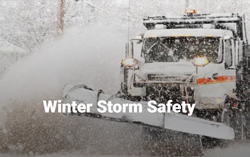 Snow plow removing snow on street.